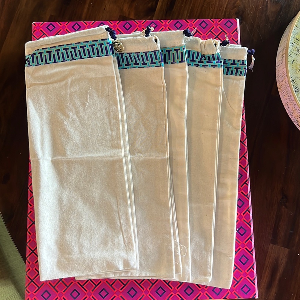 Lot of 5 Tory Burch dust covers, with charm.